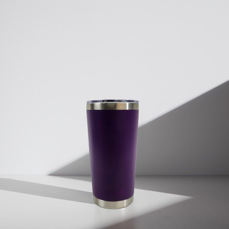 Purple tumbler with silver rim on a white background