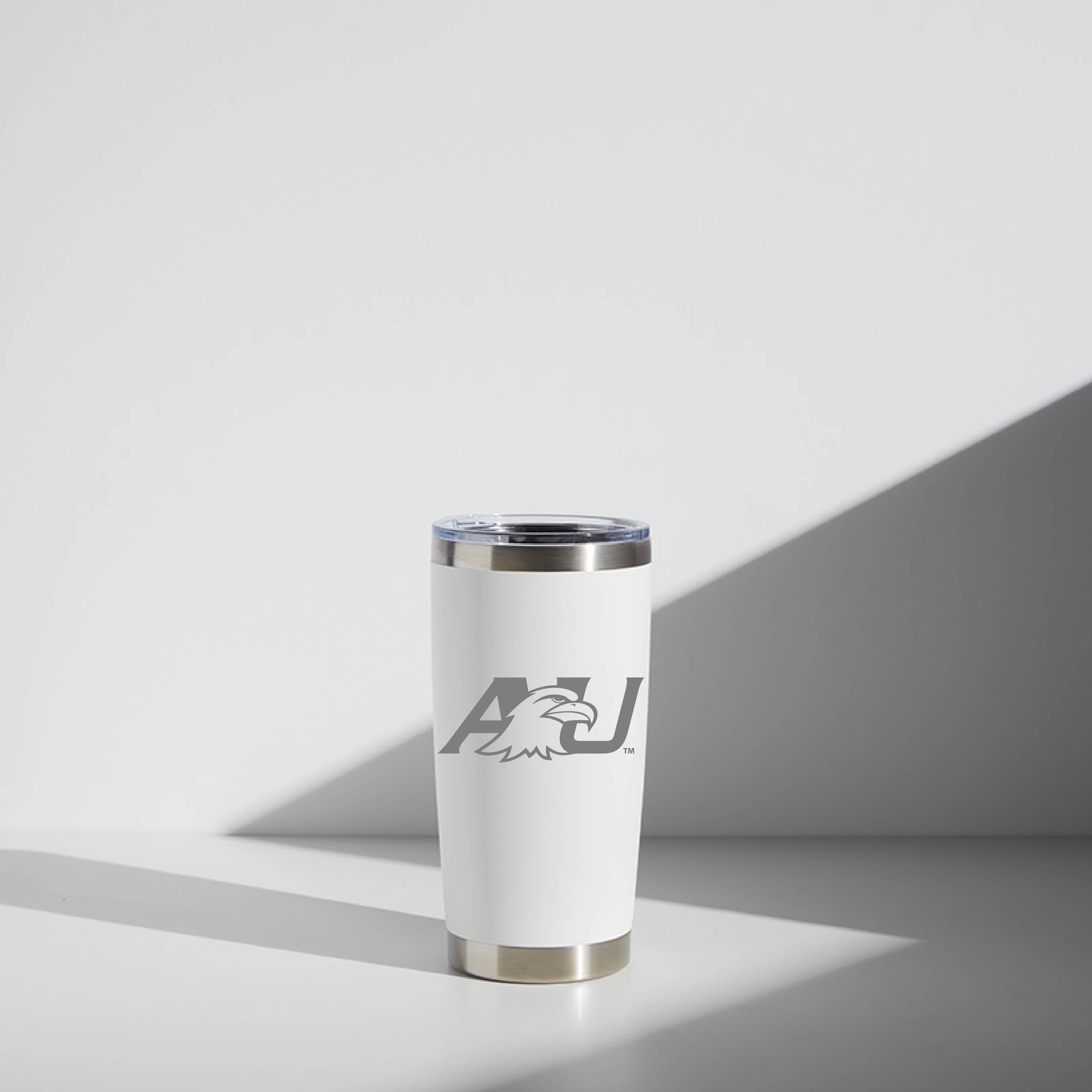 Alt text: "20 oz WATR tumbler in white featuring Ashland University logo with a stylized eagle's head, shown in a well-lit setting with a shadow cast on a white background."