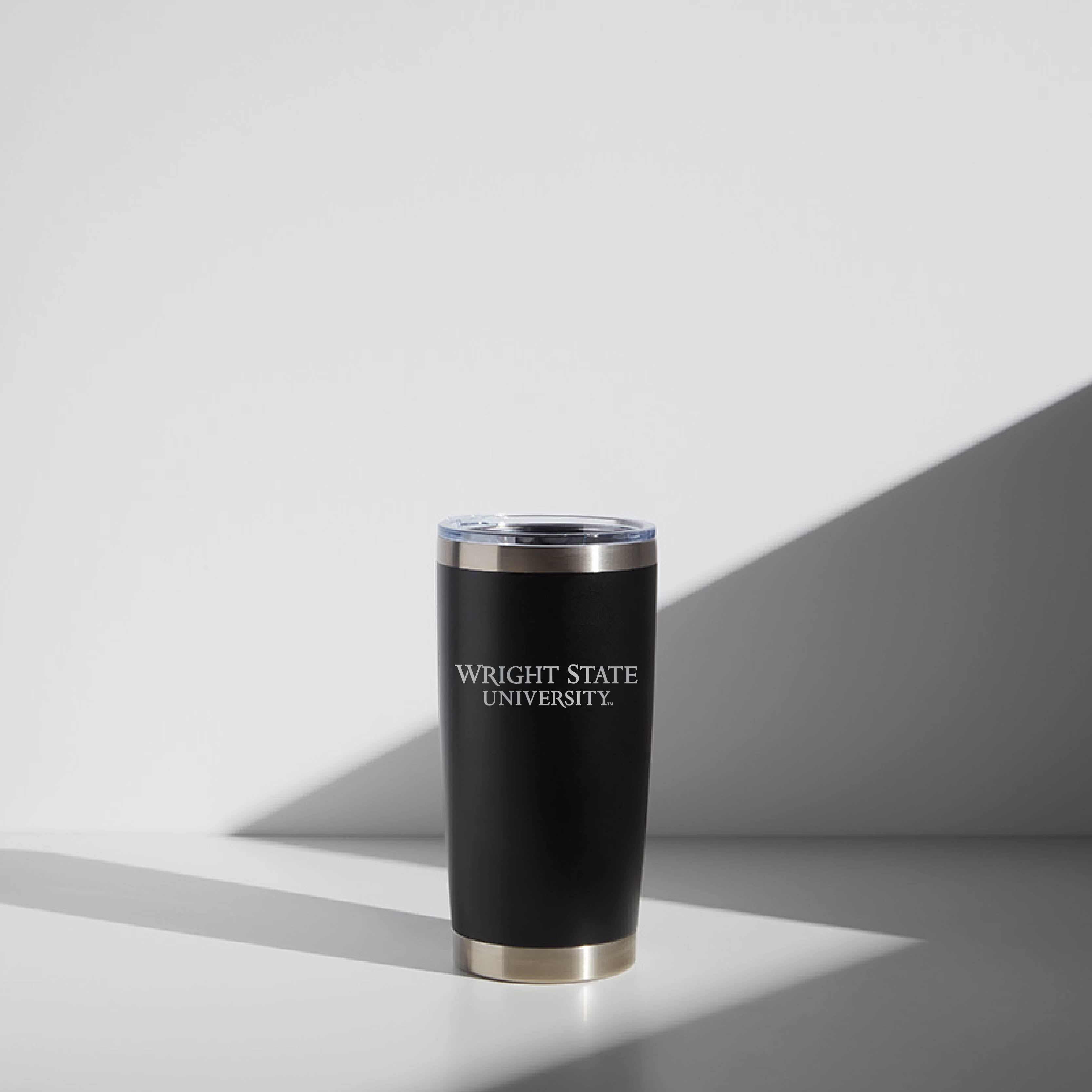 Black 20 oz WATR tumbler with Wright State University logo, featuring a clear lid, displayed on a shadowed light background.