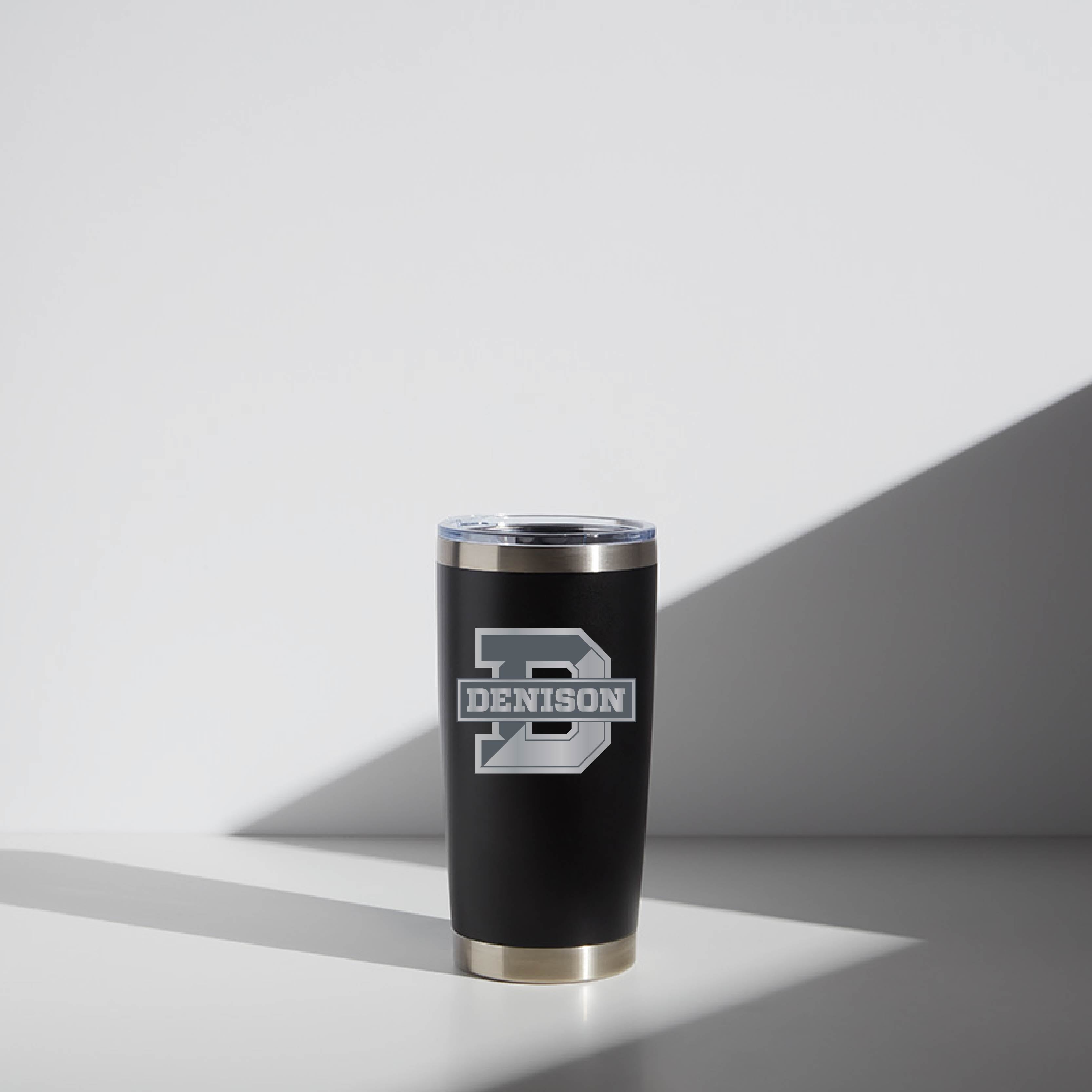 Black 20 oz WATR Tumbler with a silver rim and clear lid, featuring a white 'DENISON' logo, set against a light gray background with soft shadows.
