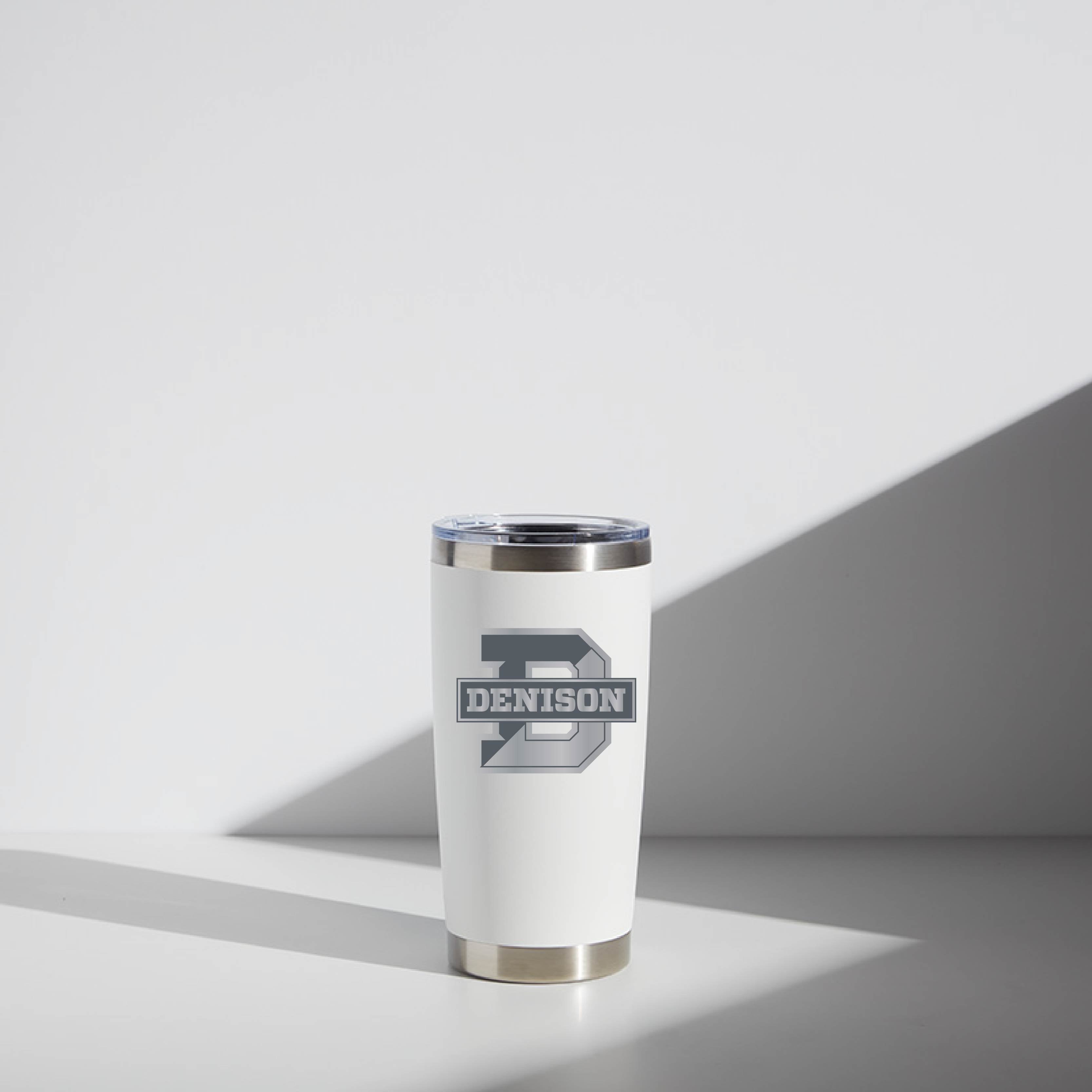 Alt text: "20 oz WATR Tumbler Denison in white with logo, featuring a stainless steel rim and base, positioned in a softly lit environment showcasing a clean and modern design."