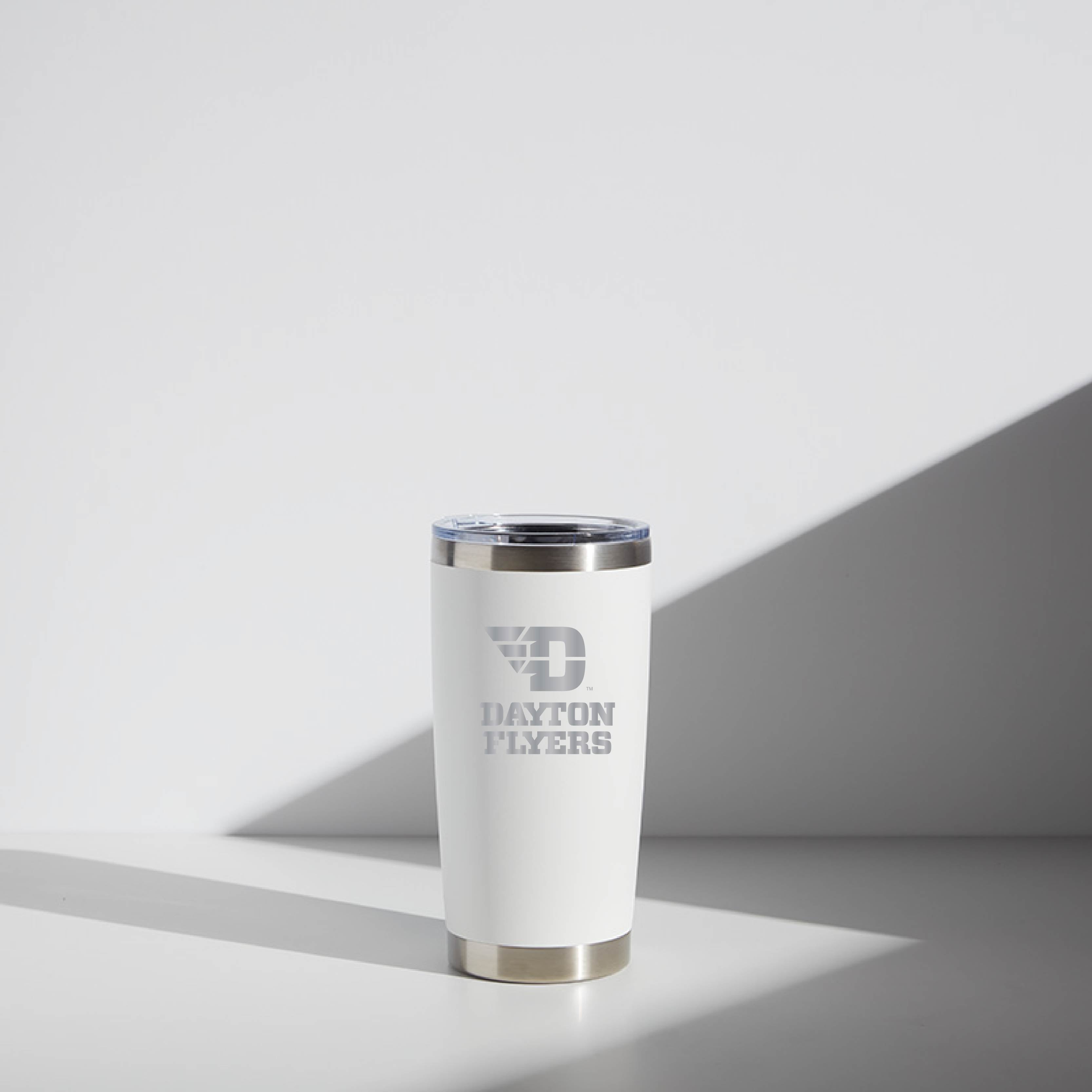 20 oz WATR tumbler with Dayton Flyers logo, featuring a silver rim and base, placed on a white surface with a shadow cast to the right.