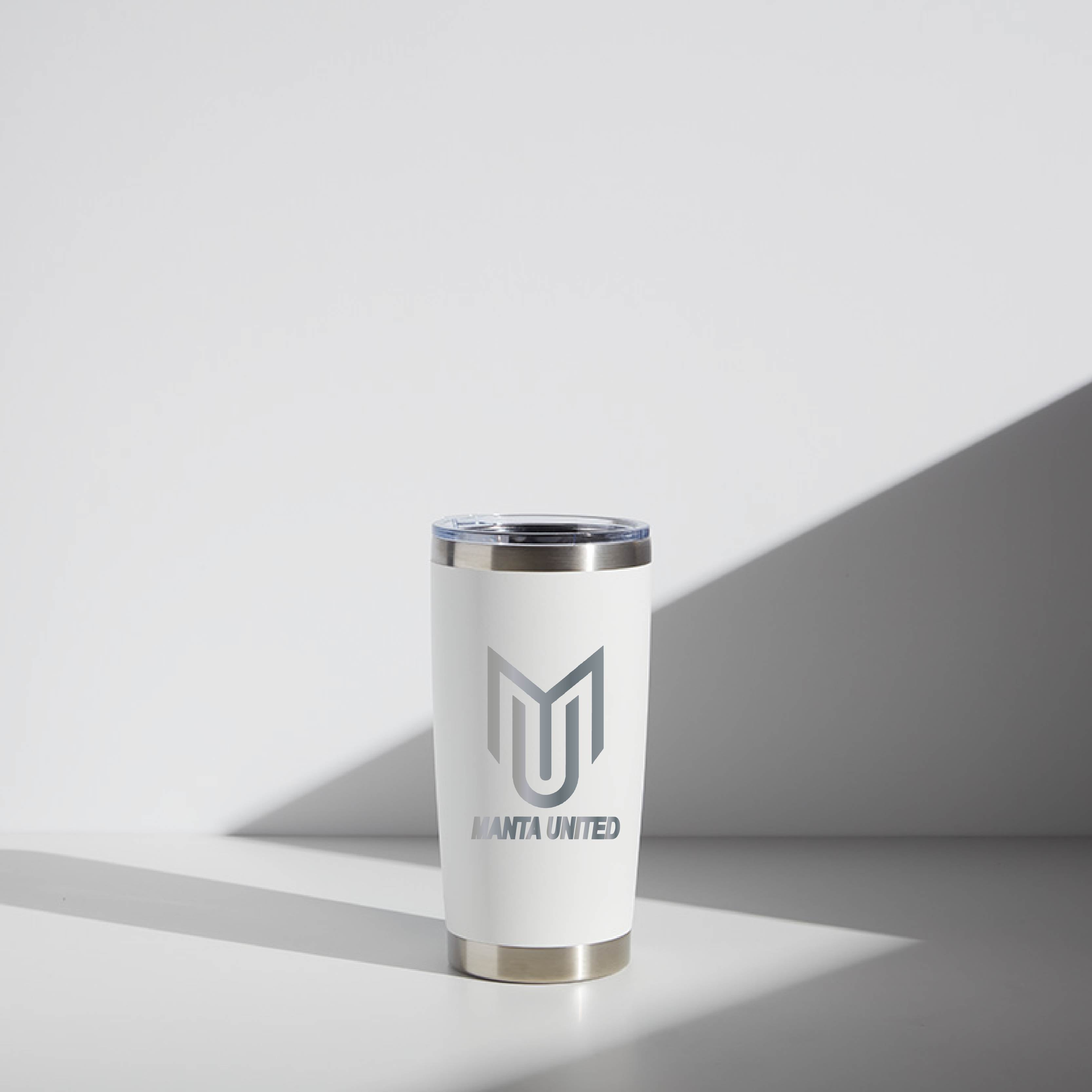 20 oz WATR Tumbler Manta United in white with a silver rim and Manta United logo, placed on a surface with a light shadow.