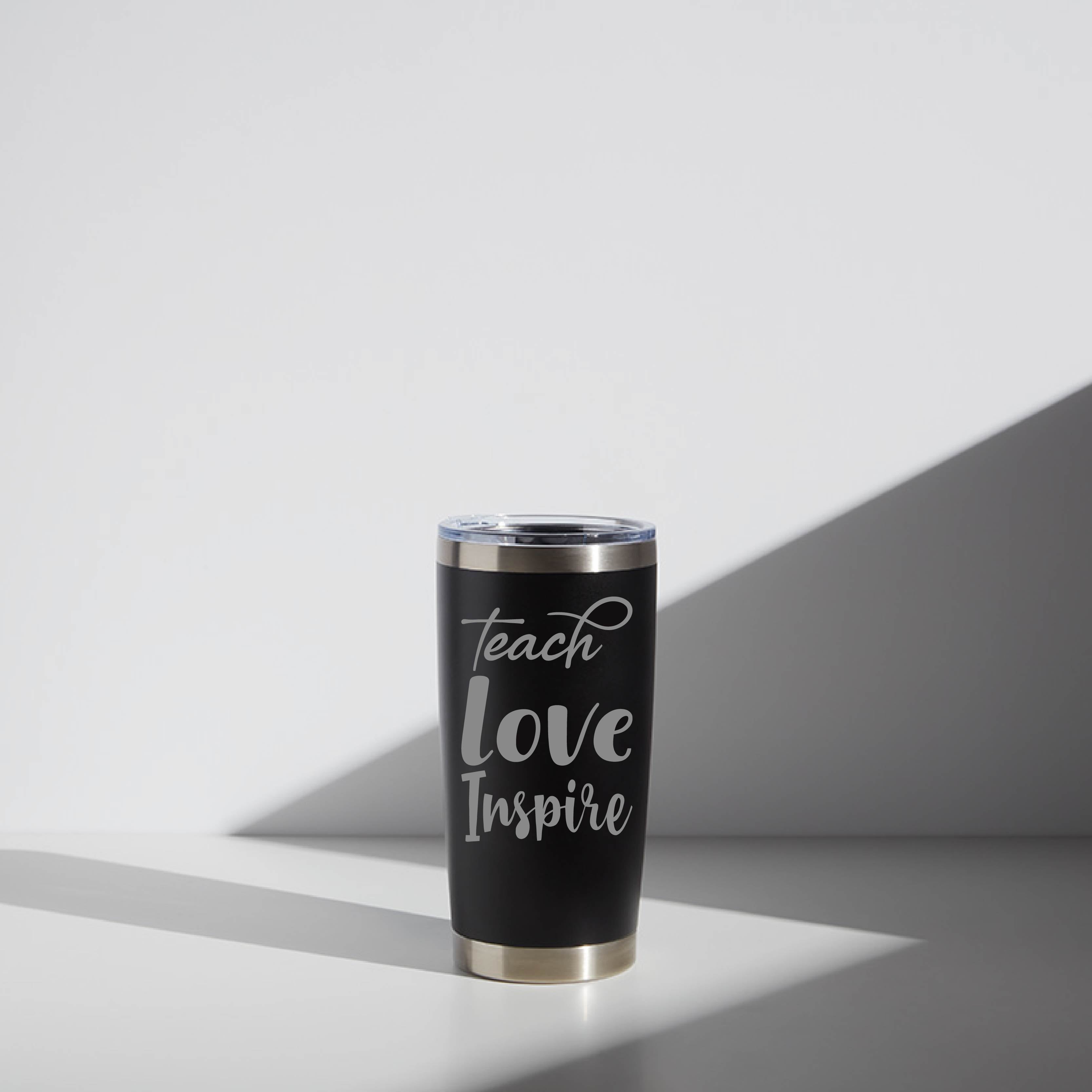 20 oz personalized stainless steel tumbler for teachers, featuring the inspirational message "Teach Love Inspire" in white script on a black background with a clear lid.