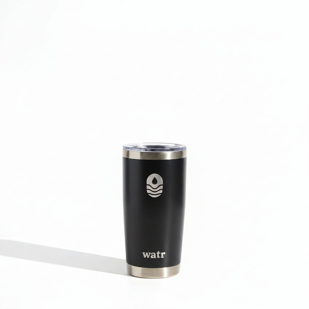 Alt text: "Black 20 oz WATR Tumbler with silver rim, featuring the Manta United Soccer logo in white, positioned on a light grey surface with a soft shadow."