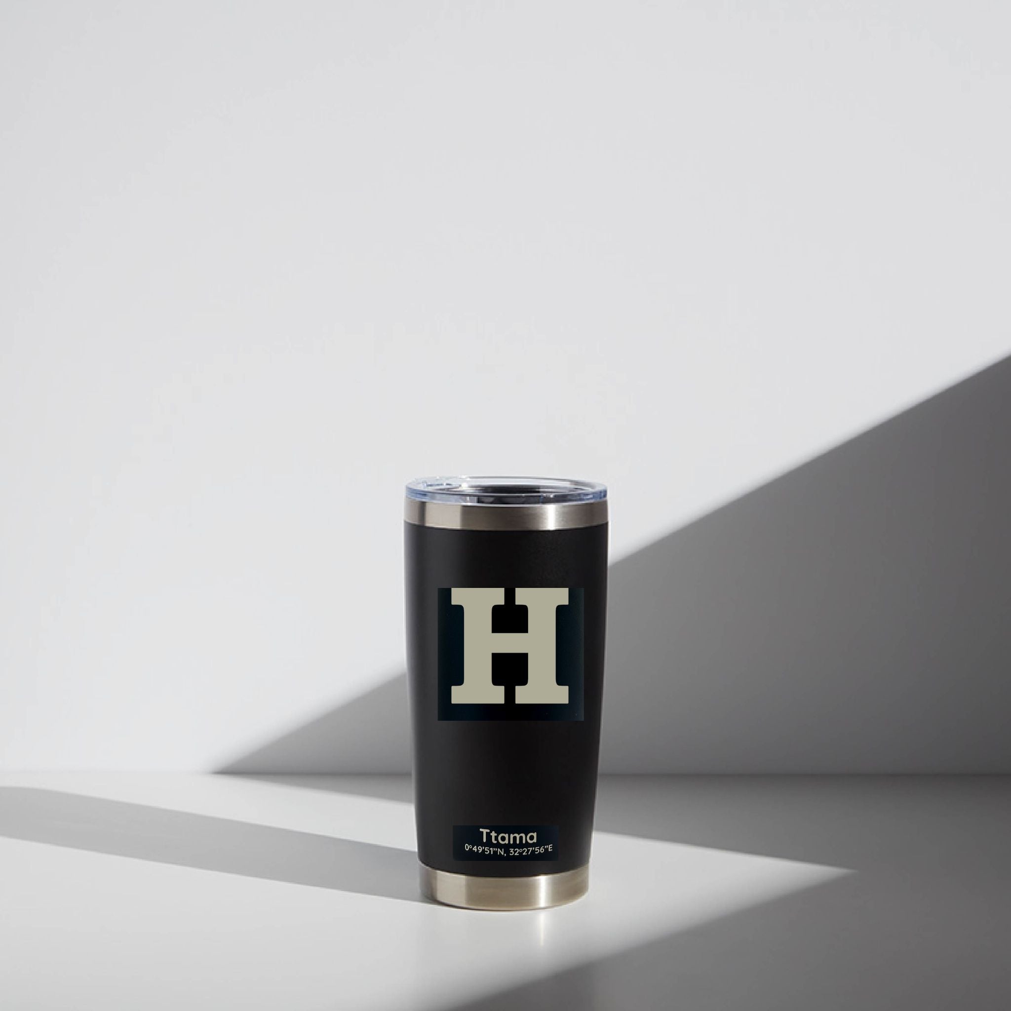 Black tumbler with a silver rim and 'H' logo on a light gray background
