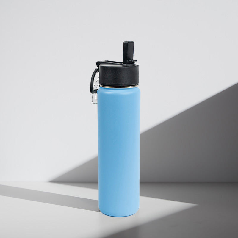 Blue water bottle with black lid on a gray background