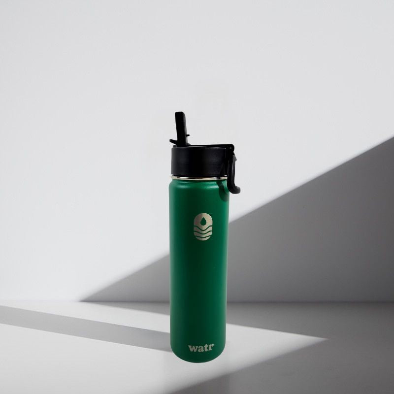 Green water bottle with black lid on a light gray background