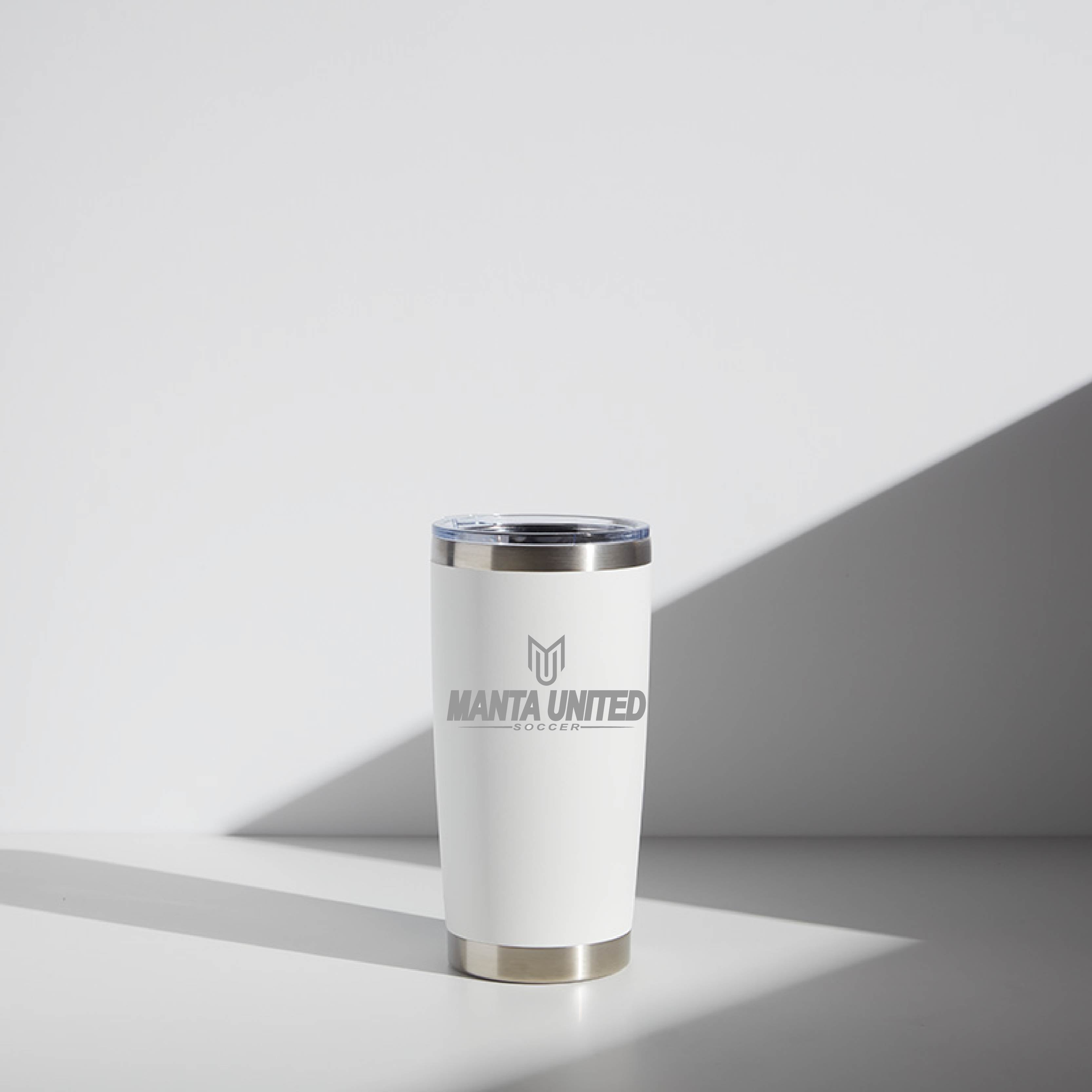 20 oz WATR Tumbler with Manta United Soccer logo in white and silver colors, displayed in a softly lit setting.