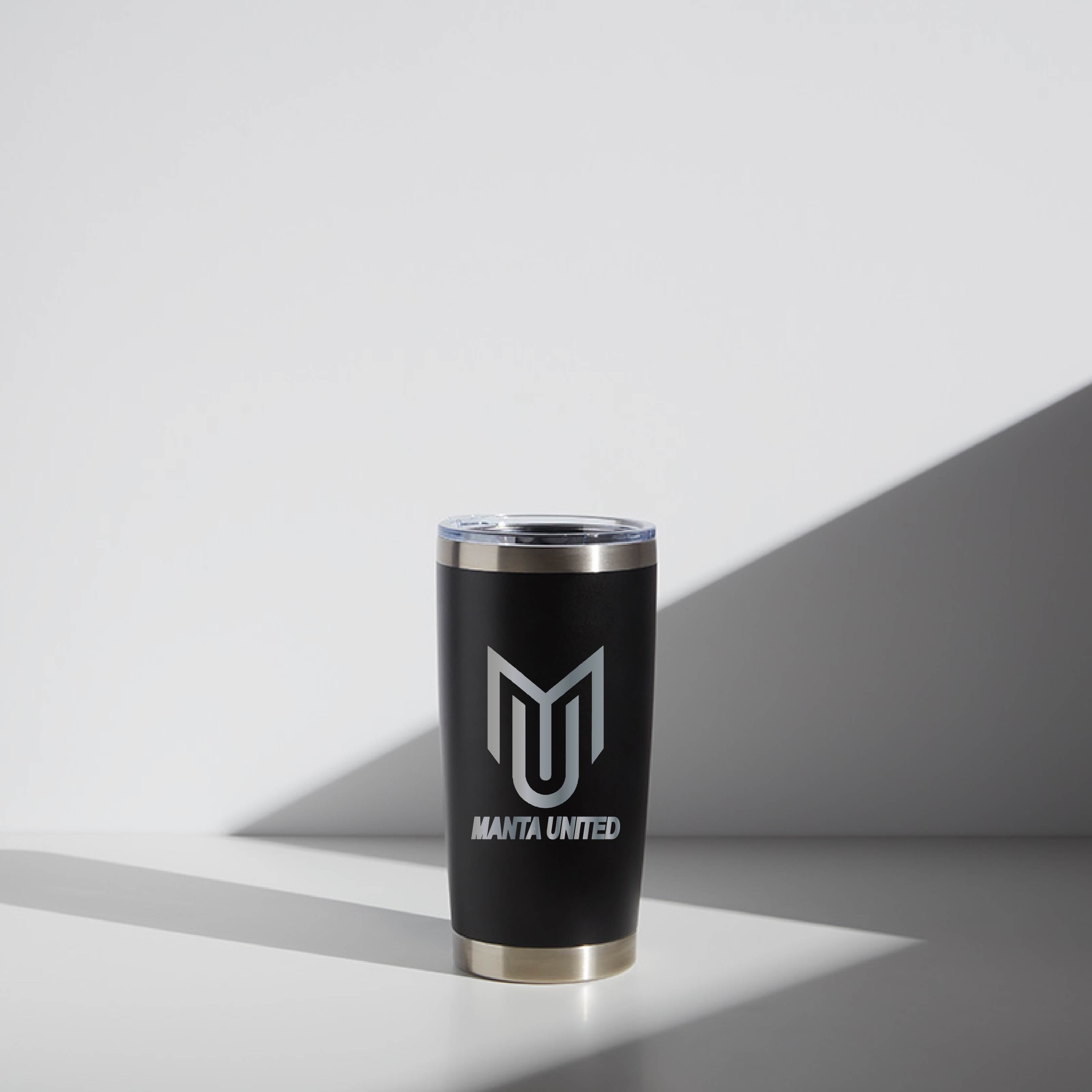 Alt text: "20 oz WATR Tumbler Manta United in black with white logo, displayed in a well-lit setting with minimalistic background."