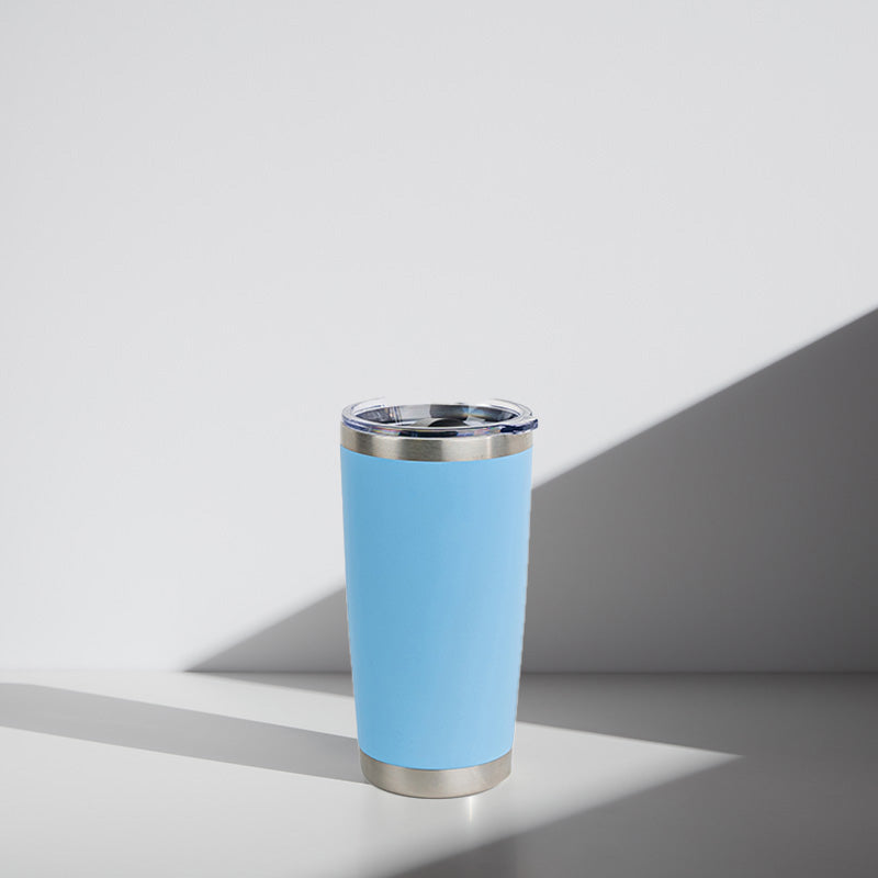 Light Blue tumbler with silver rim on a light gray background