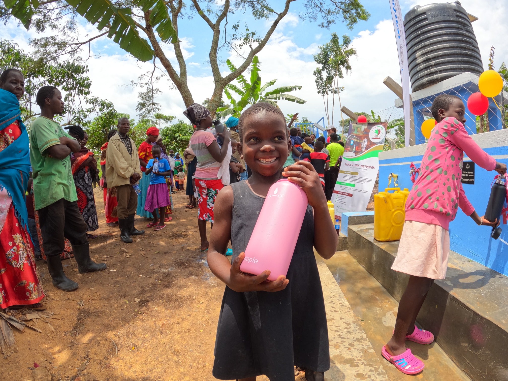 Happy Young Girl with We Are The Ripple Bottle full of Clean Water
