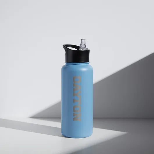 Blue "Dayton University" water bottle with black cap on a light gray background
