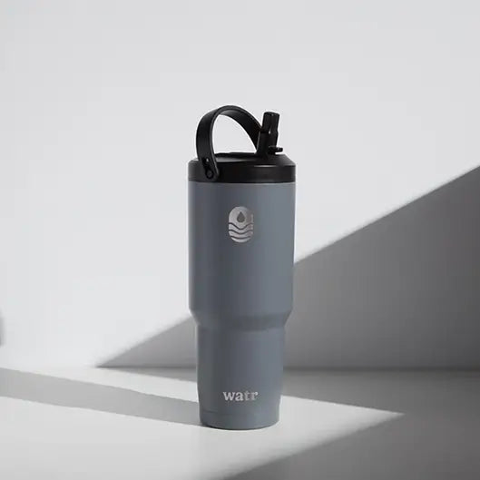Custom gray Watr insulated golf tumbler with black flip lid and carry handle, engraved with a watr logo
